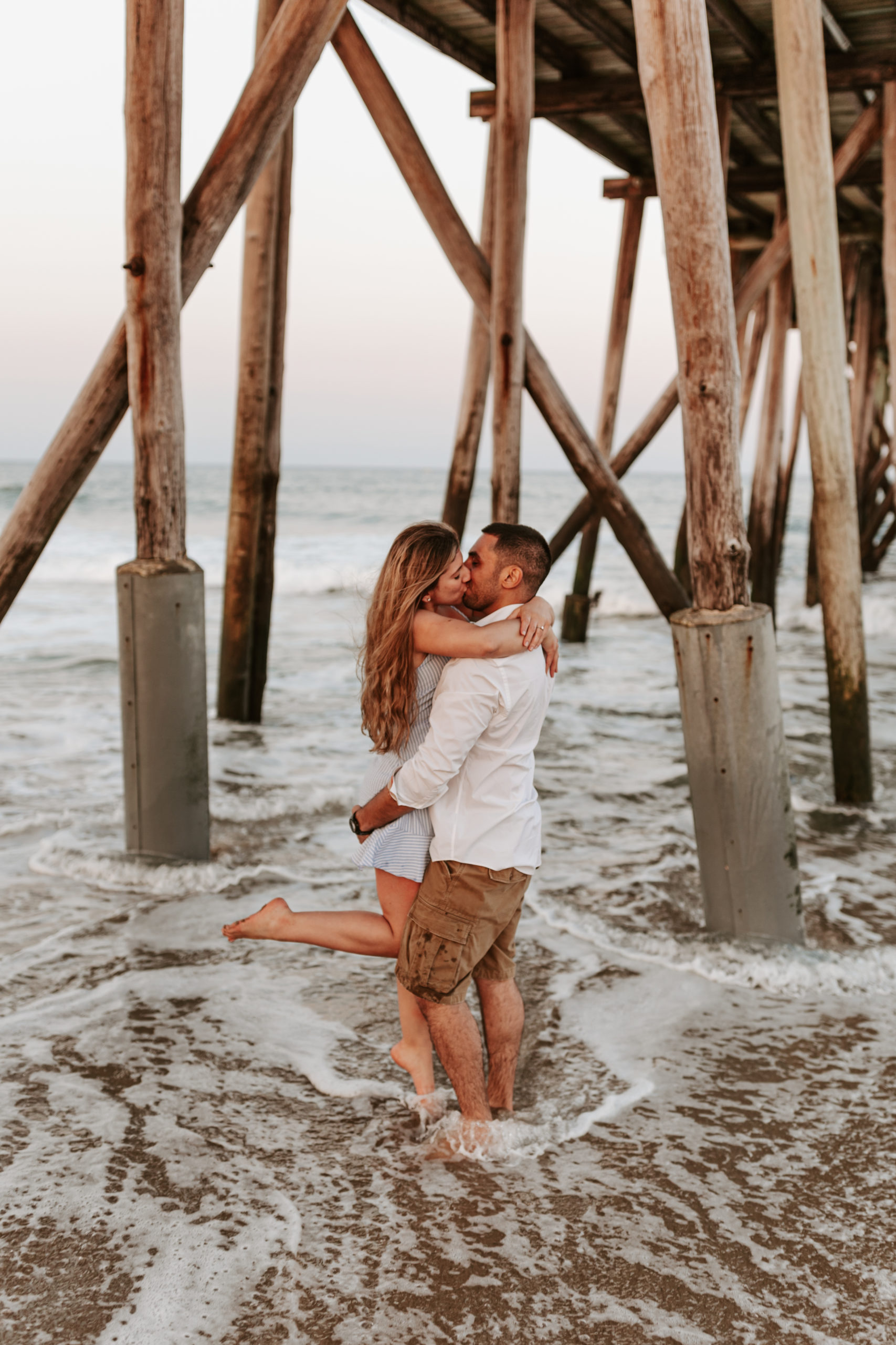 Couple kissing in water at Engagement Session at Belmar Beach NJ